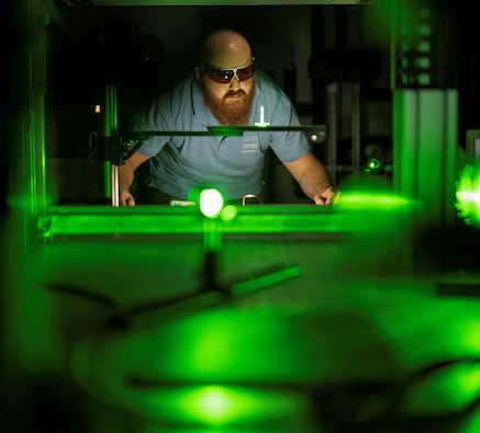 Man works with laser system
