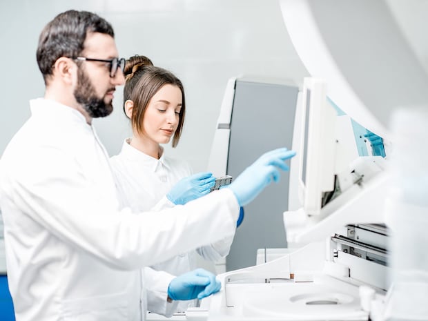 Laboratory assistants in unifrom working at the laboratory