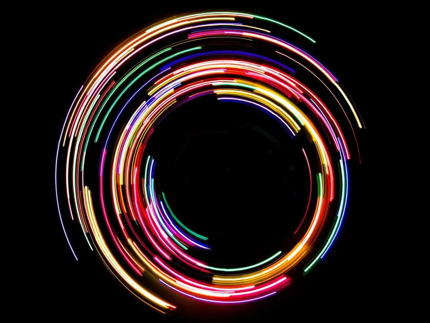 Abstract rotating neon lights on black background