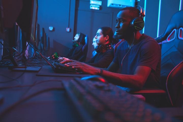 Video gamers in a bluish dark room