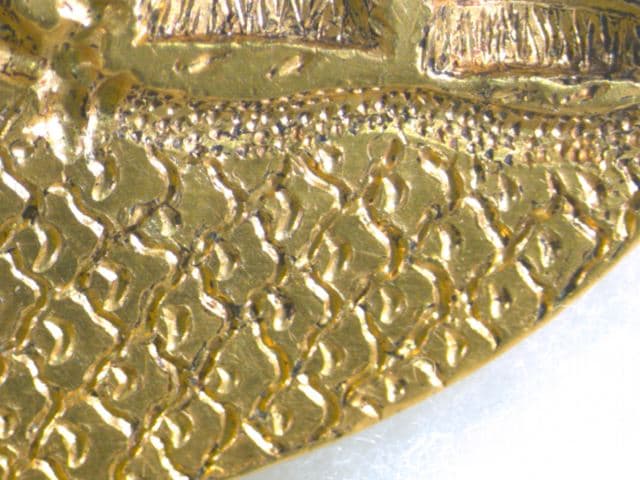 Microscope image of gold signet ring: details of the carving